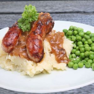 Sausages with potato mash with peas and gravy